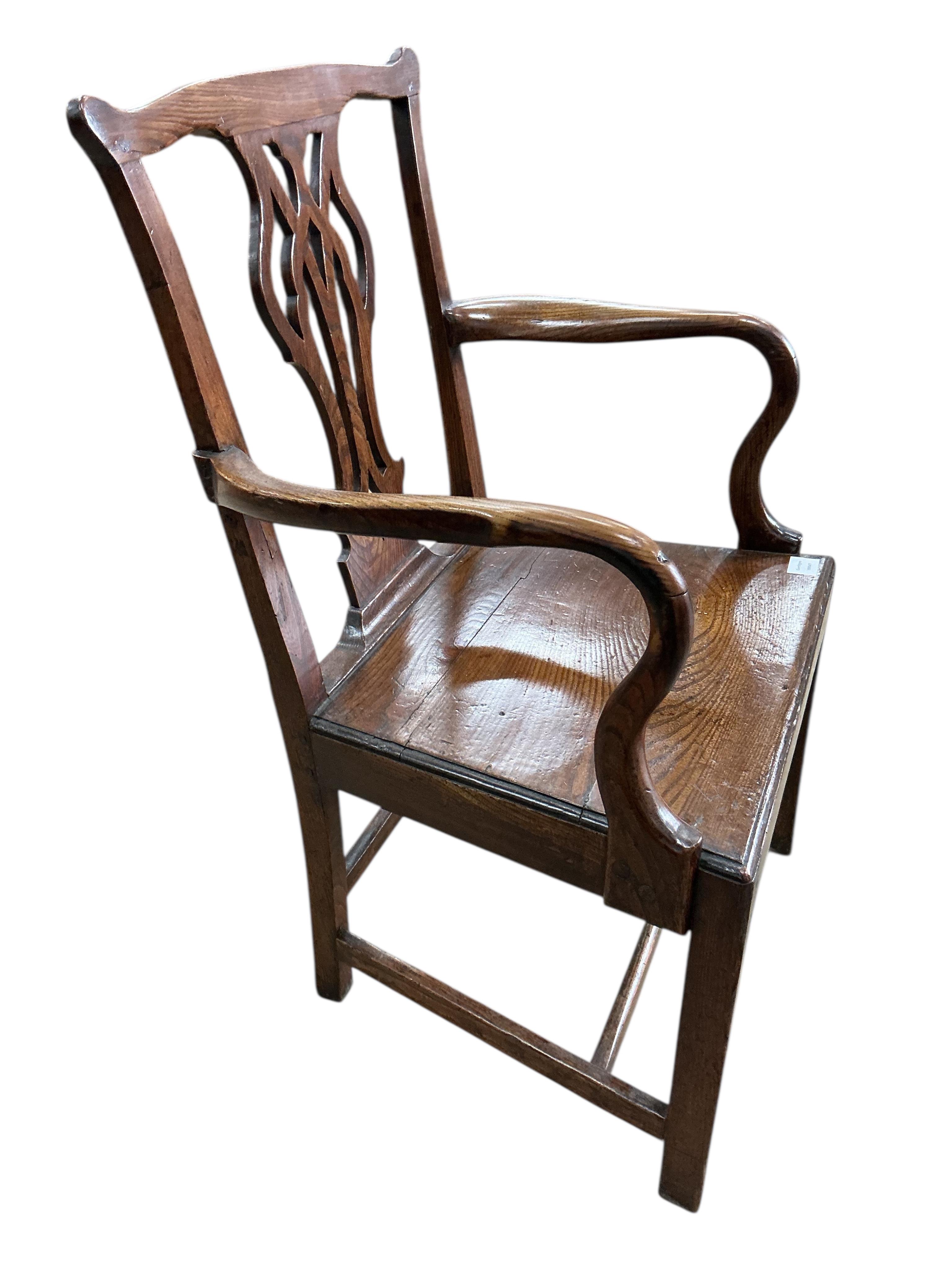 A George III Provincial oak wood seat elbow chair, width 60cm, depth 46cm, height 96cm